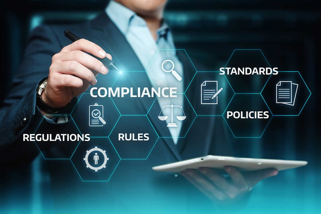 A businessman interacts with compliance-related icons representing regulations, rules, standards, and policies on a digital screen.