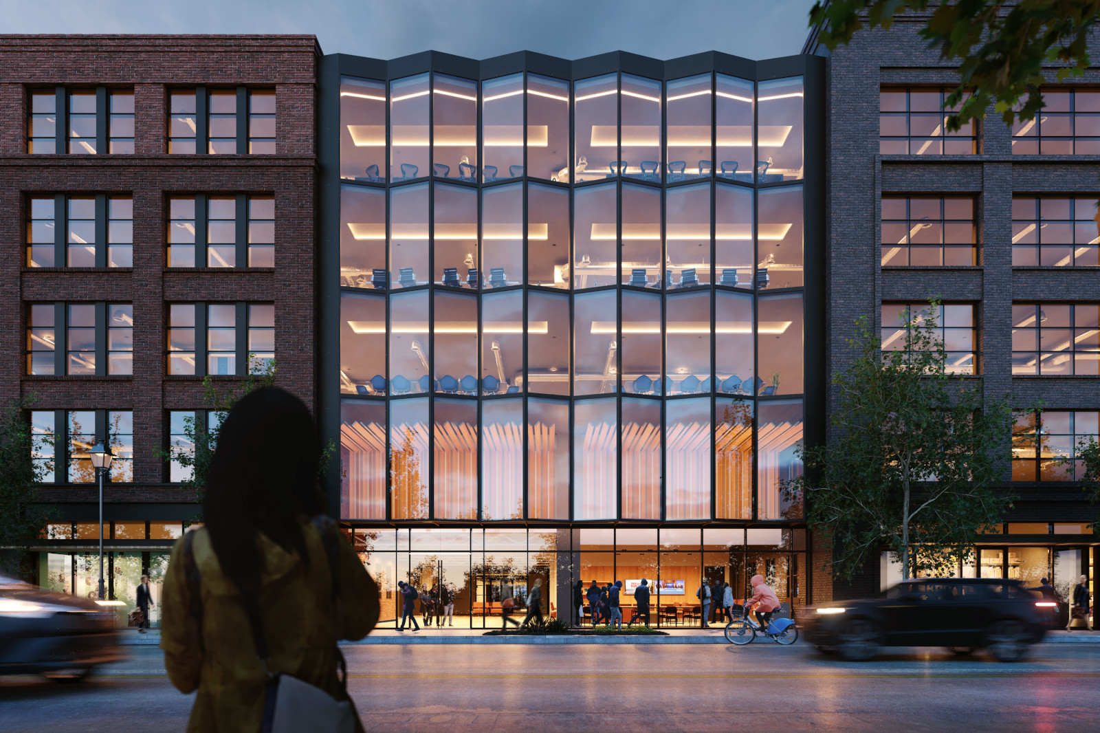 A modern glass-fronted building with a wavy facade, showcasing vibrant interiors and people walking along the street.