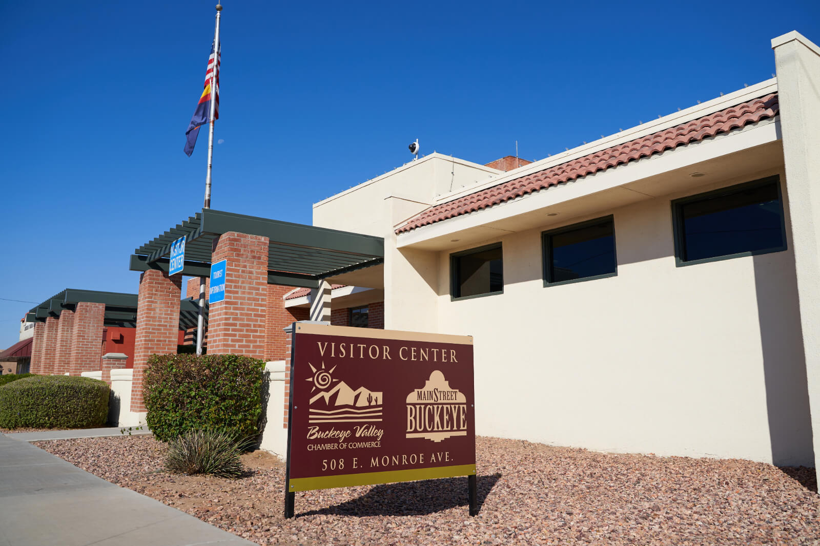 The Buckeye Valley Visitor Center features a welcoming sign, with a clear blue sky overhead and modern architecture.